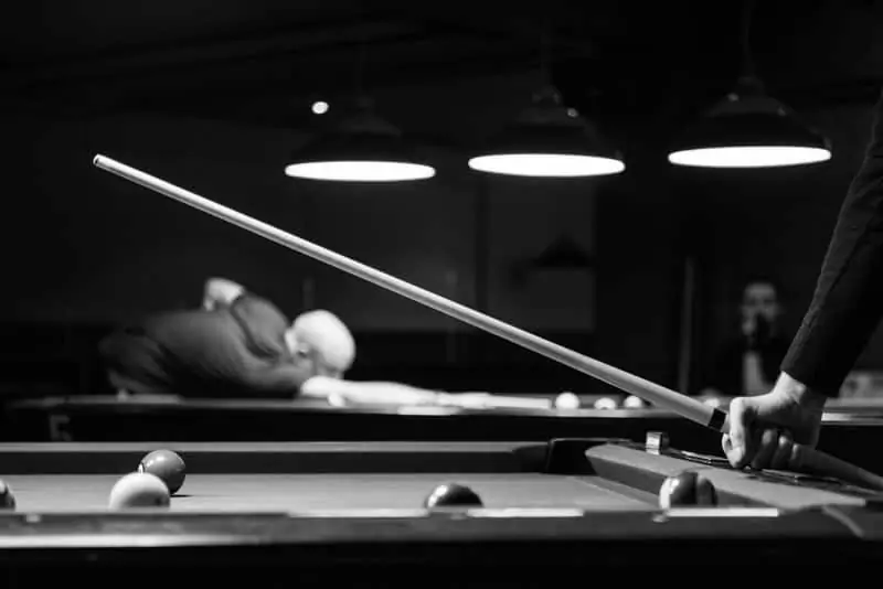 Man Holding Pool Cue in Greyscale