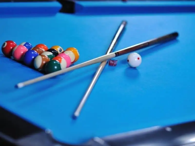 Billiards table with stick and balls