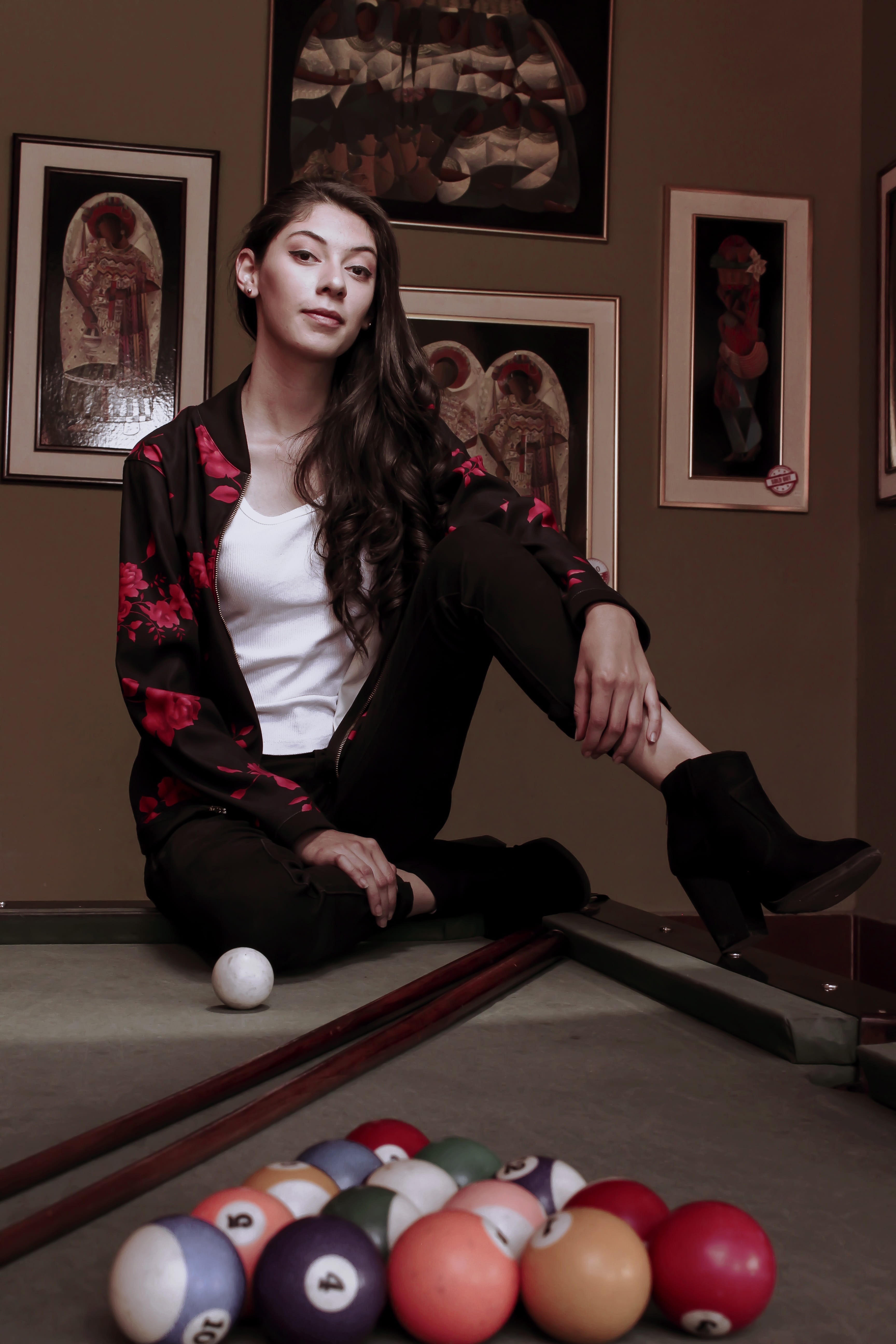 Attractive model posing on a wooden billiards table